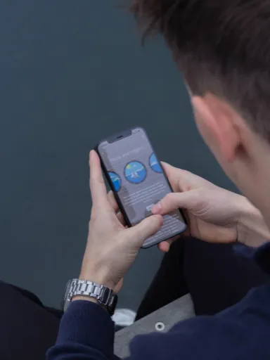 Man holding phone with Meta Learn App