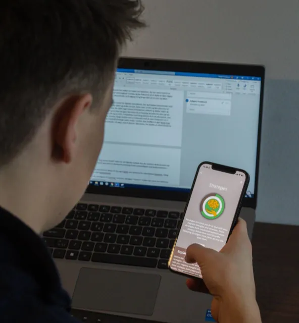 ?Man studying and holding phone with Meta Learn app