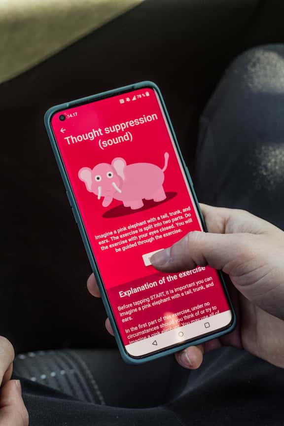 Holding a phone with the Meta Learn app.